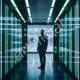Man in Suit in Futuristic Neon-Lit Corridor